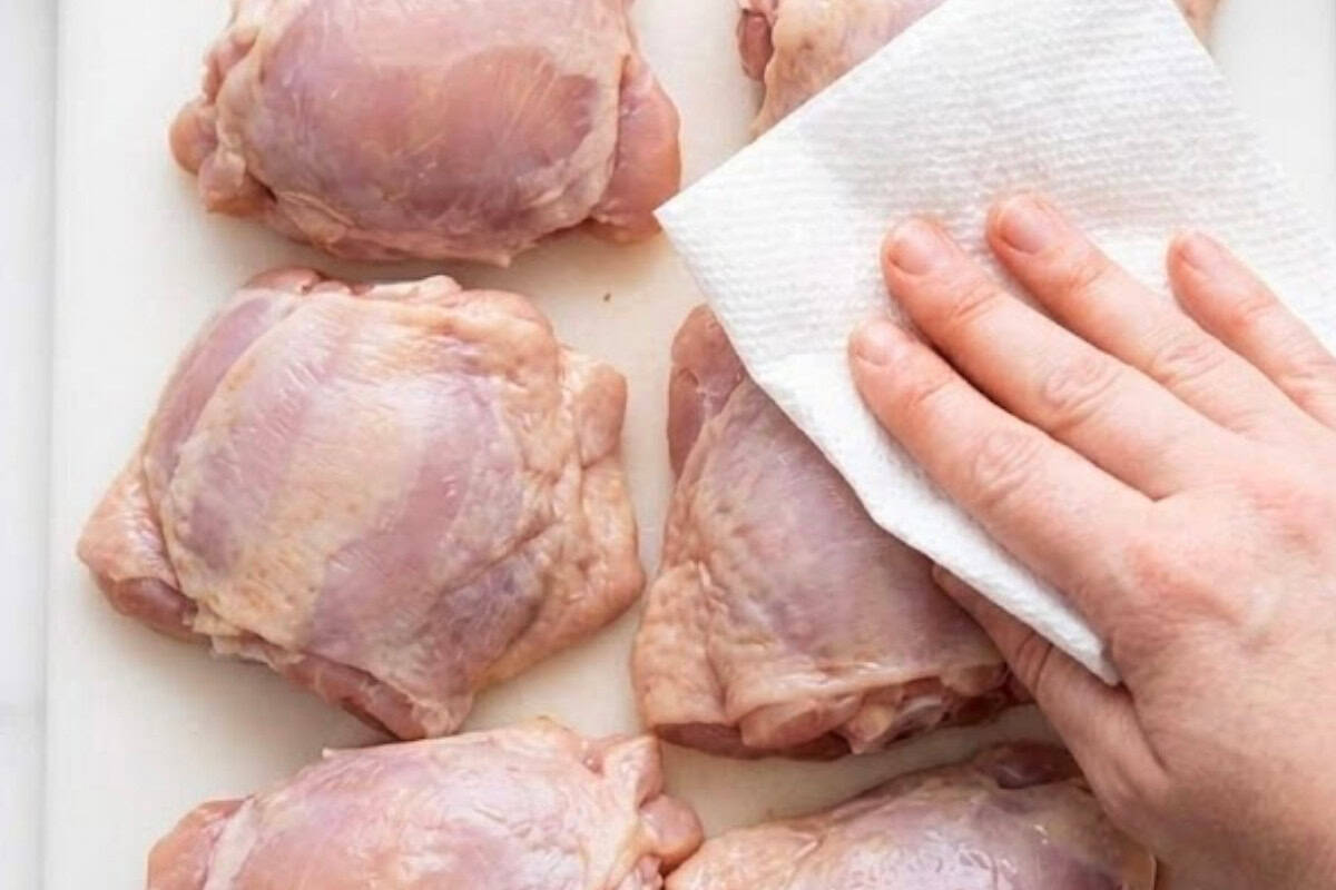 Pat the bone in, skinless chicken thighs completely dry with paper towel. 