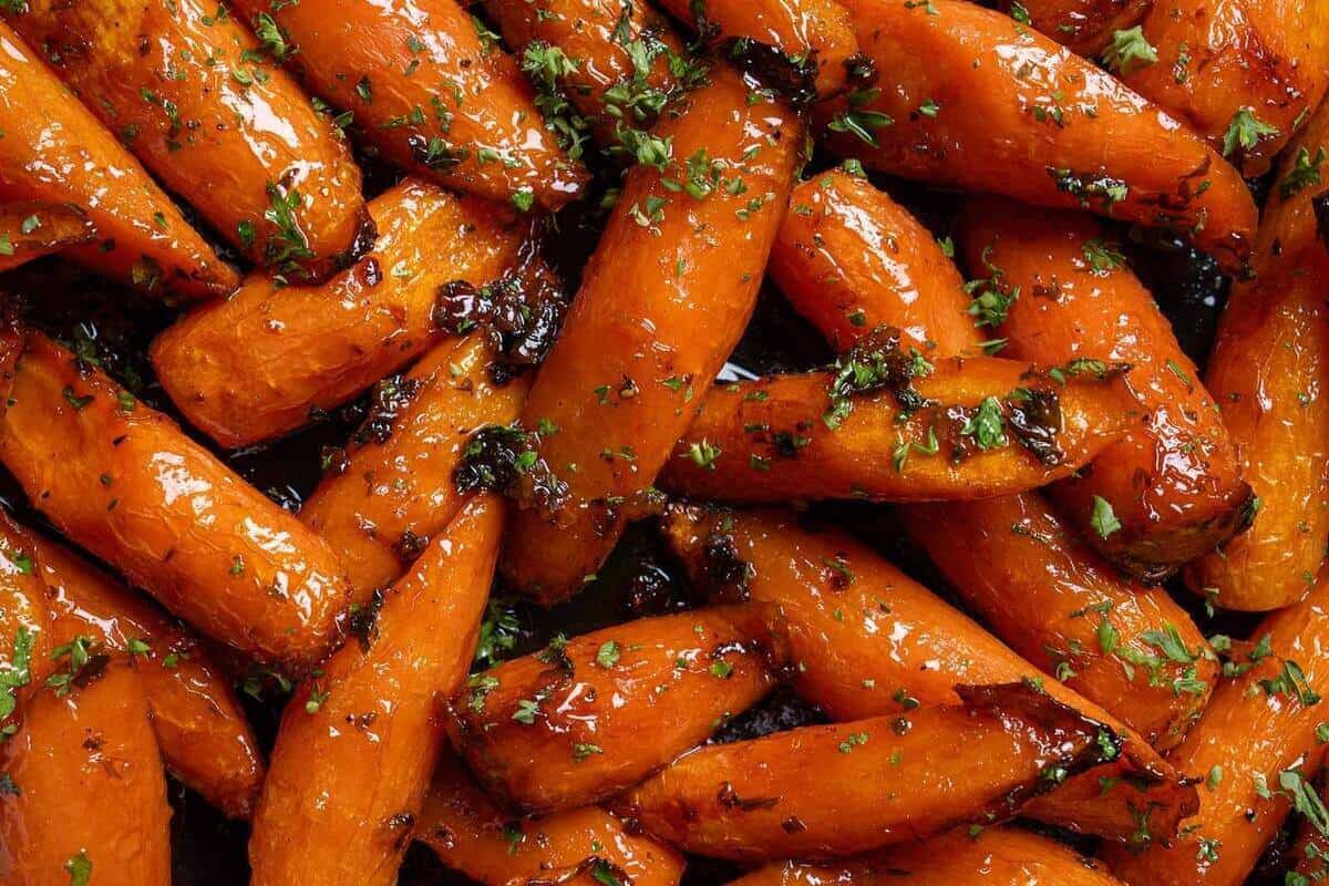 Close-up image of the carrots sprinkled with salt, pepper, and parsley, ready to be served.