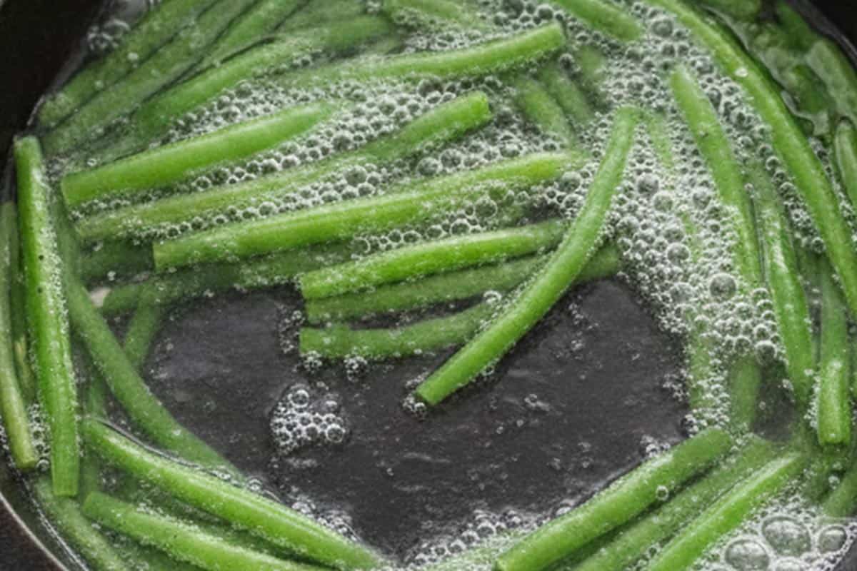 Green beans in a pan with boiling water.