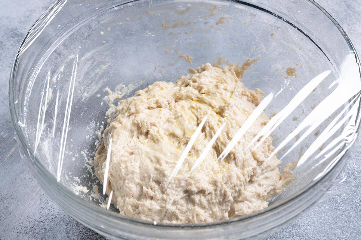 The bowl containing all the ingredients is lightly sprayed with cooking oil and covered with cling wrap.