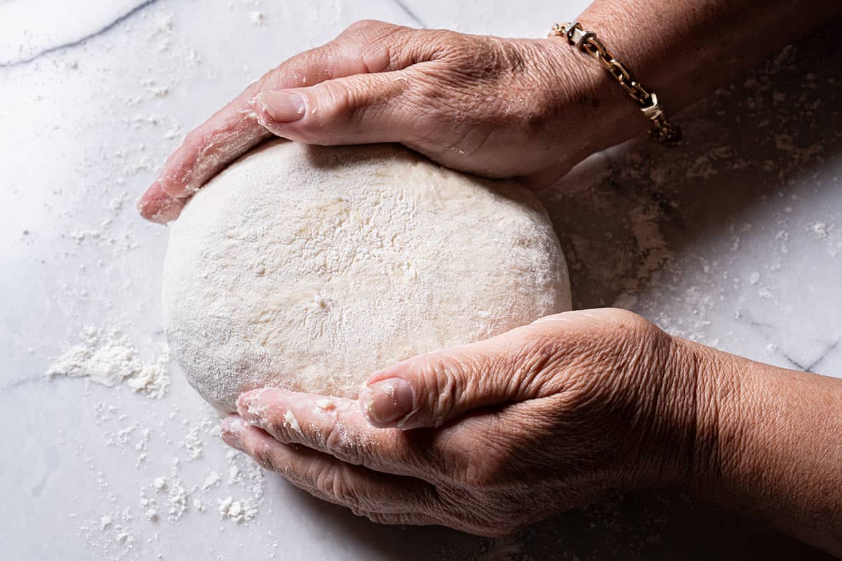 Image of hands turning the though into a well-rounded shape.