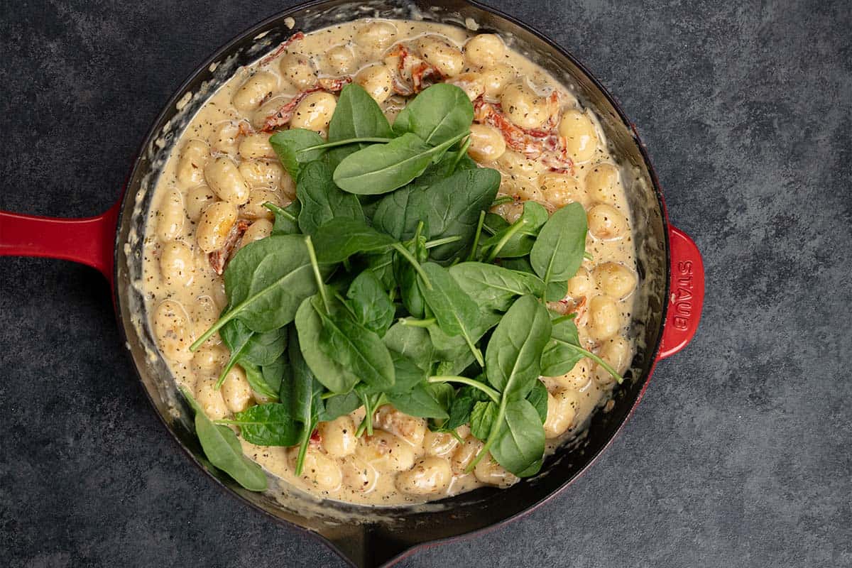 adding spinach to the gnocchi