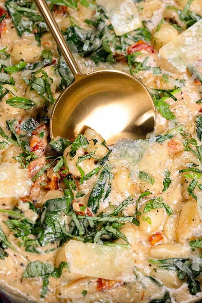 A close up image of creamy gnocchi.