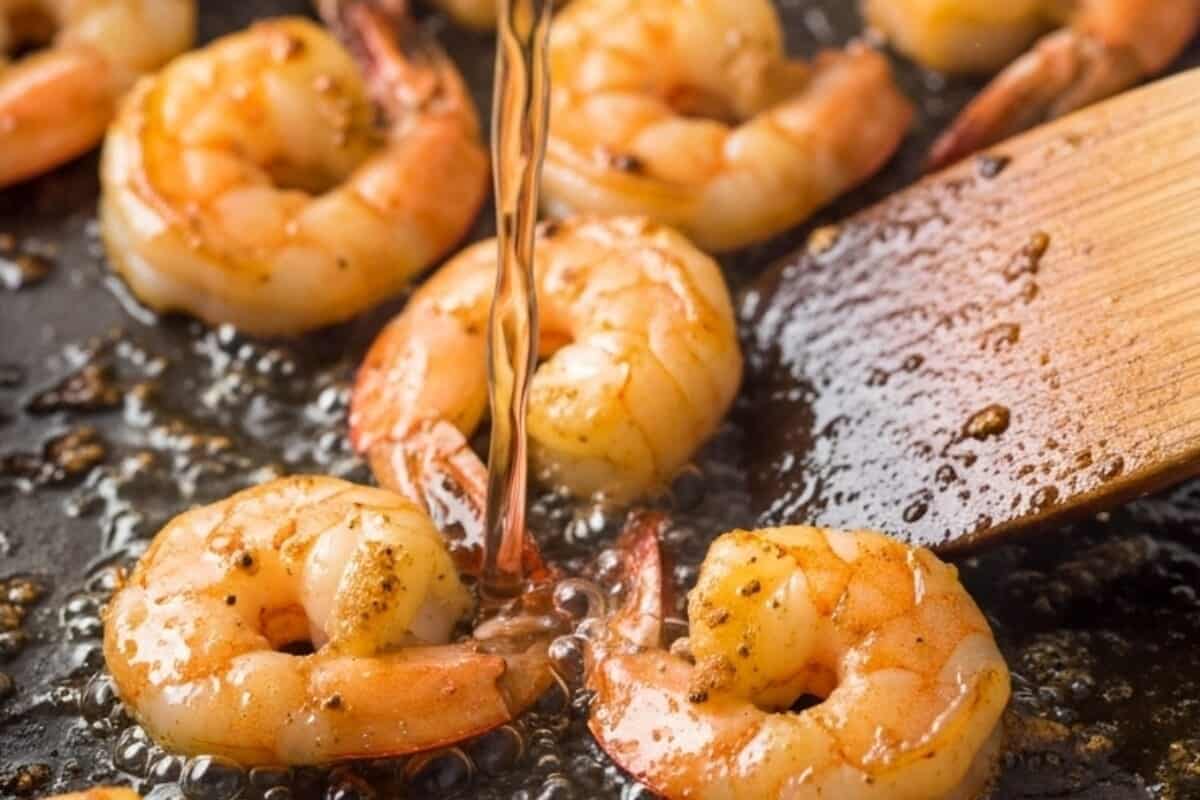 Pour in white wine to deglaze the pan