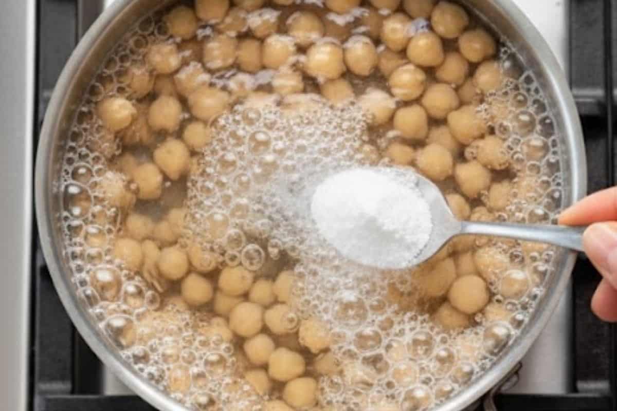 Add chickpeas into a small pot, cover with water, and stir in baking soda.