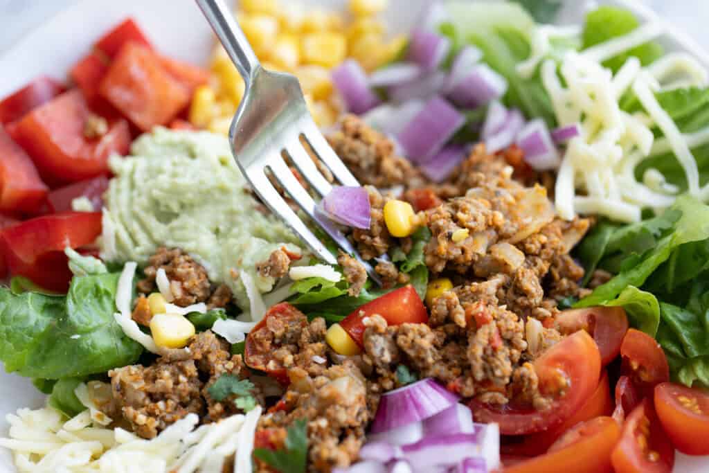close up of fork in finished taco salad. 