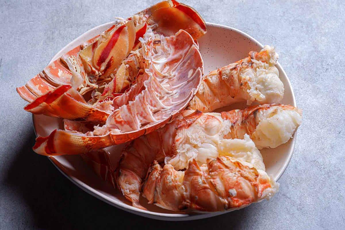 Lobster tail meat being separated from the shells.