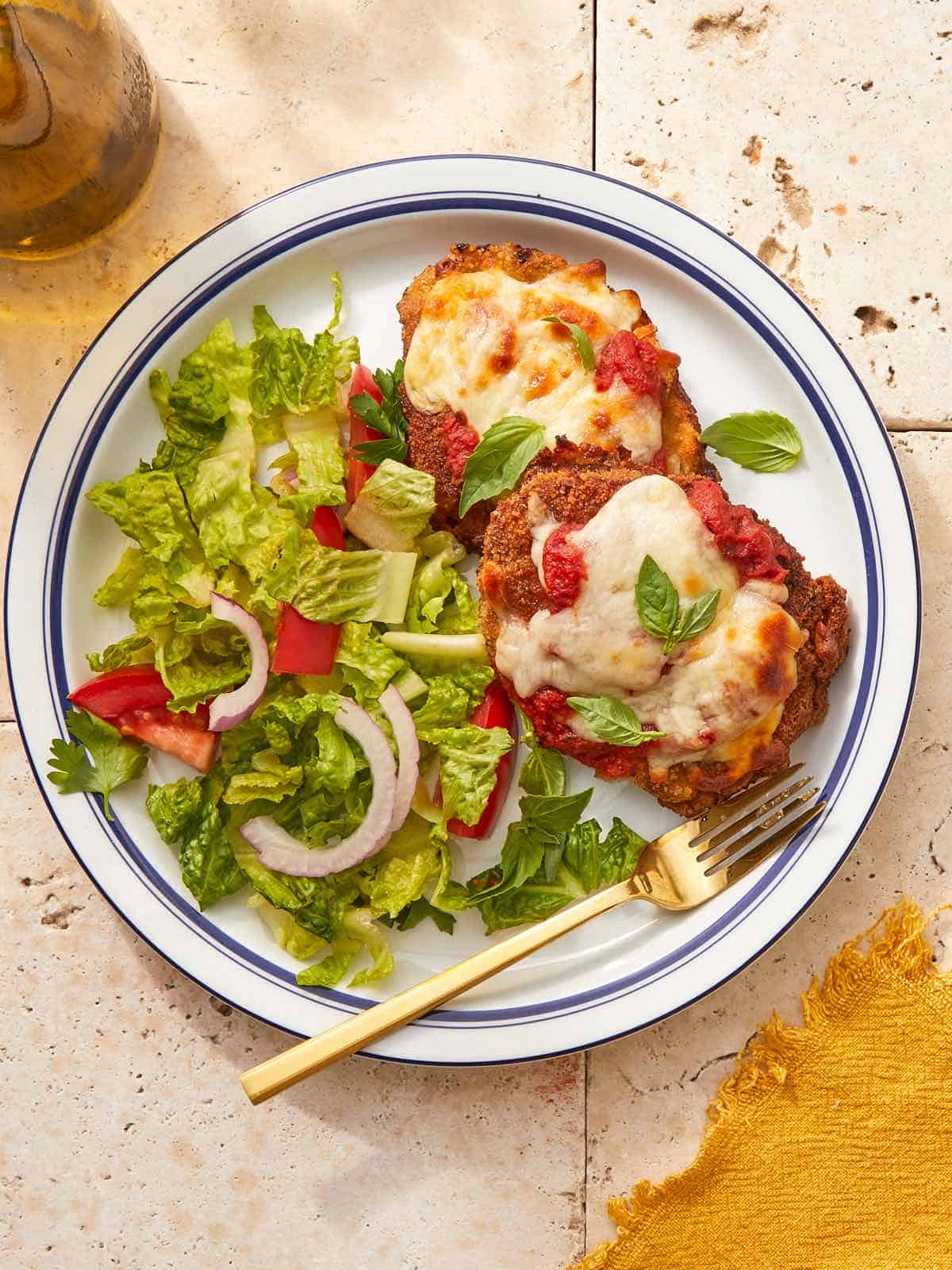 Plate of crispy beef schnitzel Parmigiana.