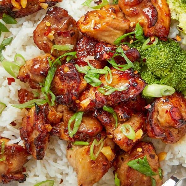 Air fryer teriyaki chicken served over rice with broccoli and sliced green onions