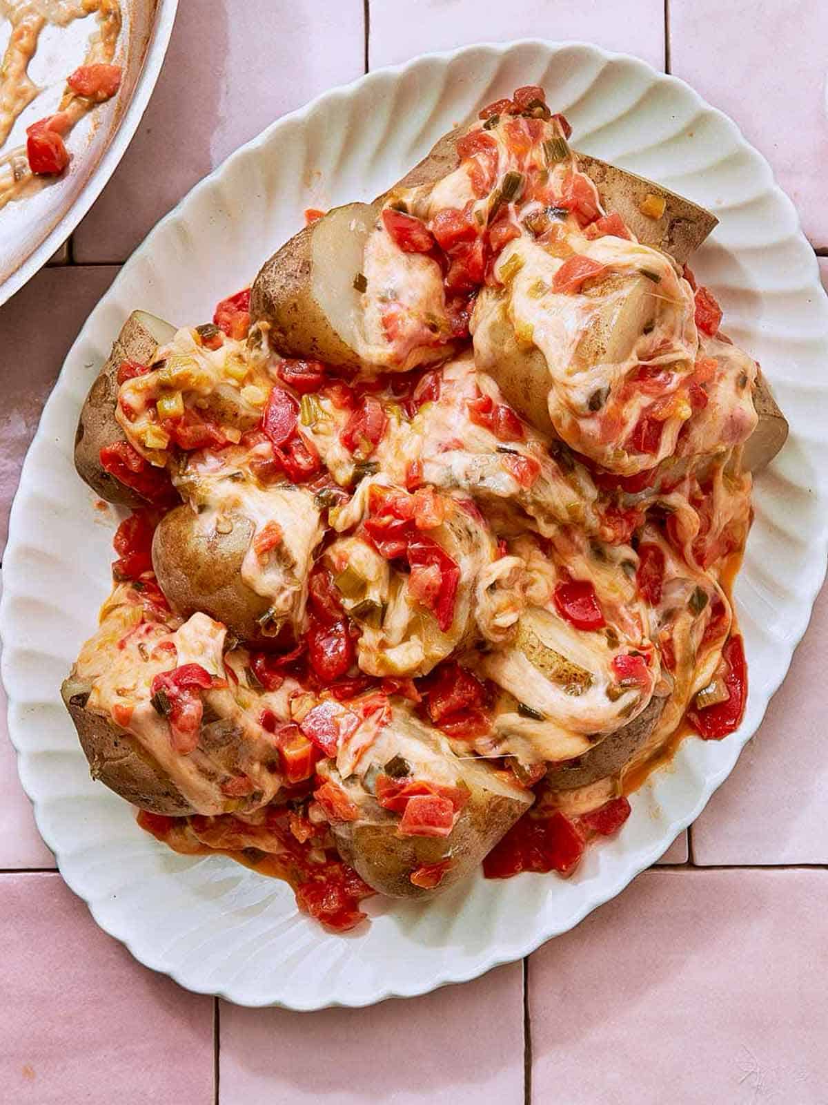 Cheesy Potatoes, also known as Papas Chorreadas on a white serving plate.