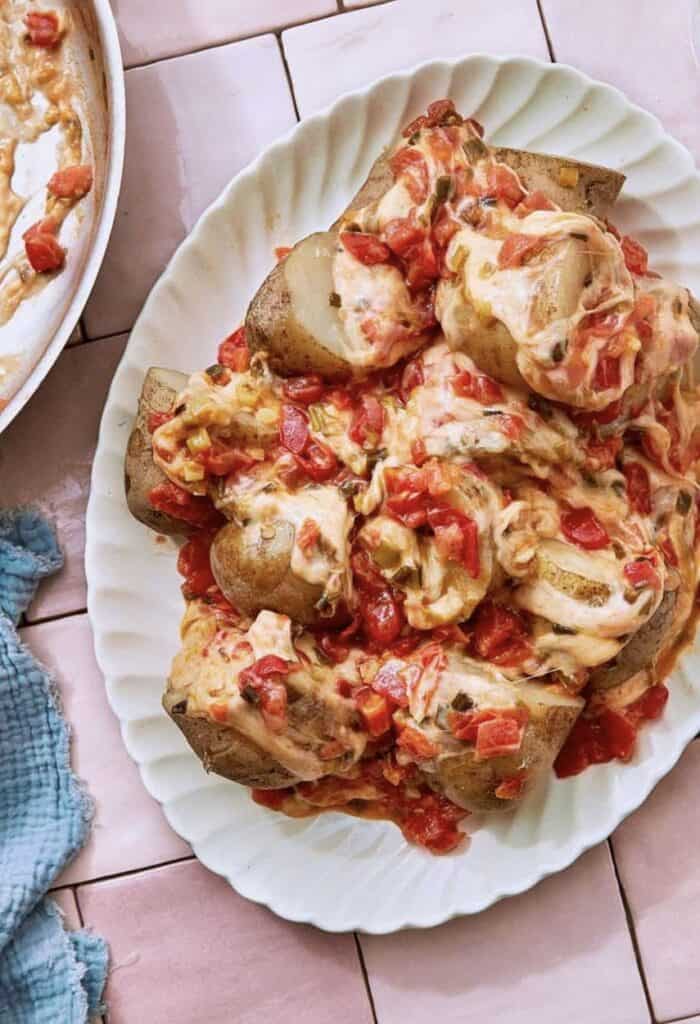 Cheesy Potatoes, also known as Papas Chorreadas on a white serving plate.