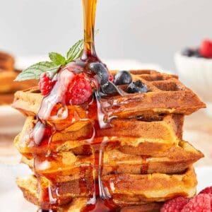 A close-up of Wancakes topped with syrup being drizzled