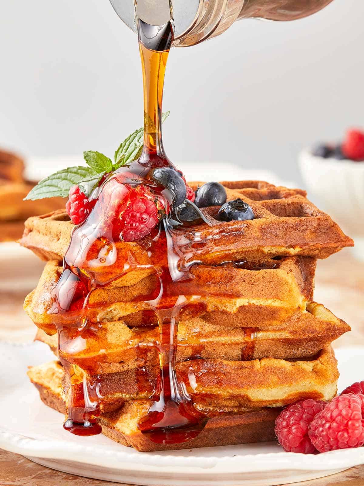 A close-up of Wancakes topped with syrup being drizzled