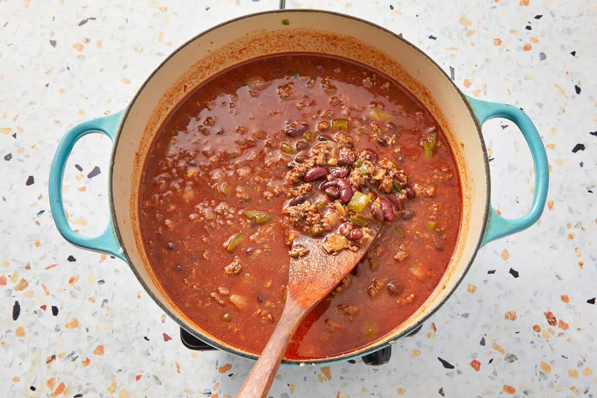 Simmered beef chili bubbling in the pot, thick and ready to serve.