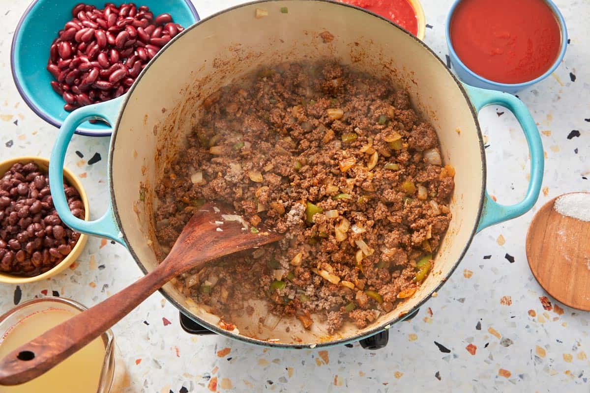 Browned ground beef fully cooked and seasoned, ready for liquids.