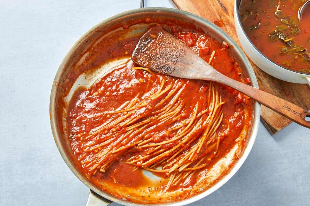 Cooked pasta coated in sauce, stirred until perfectly al dente with a rich tomato base.