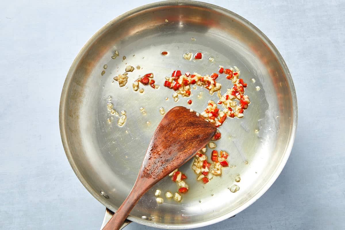 Finely chopped chili added to golden garlic, infusing heat into the creamy tomato pasta sauce.