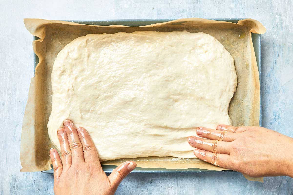 Dough placed into the prepared pan and pressed out with fingers.