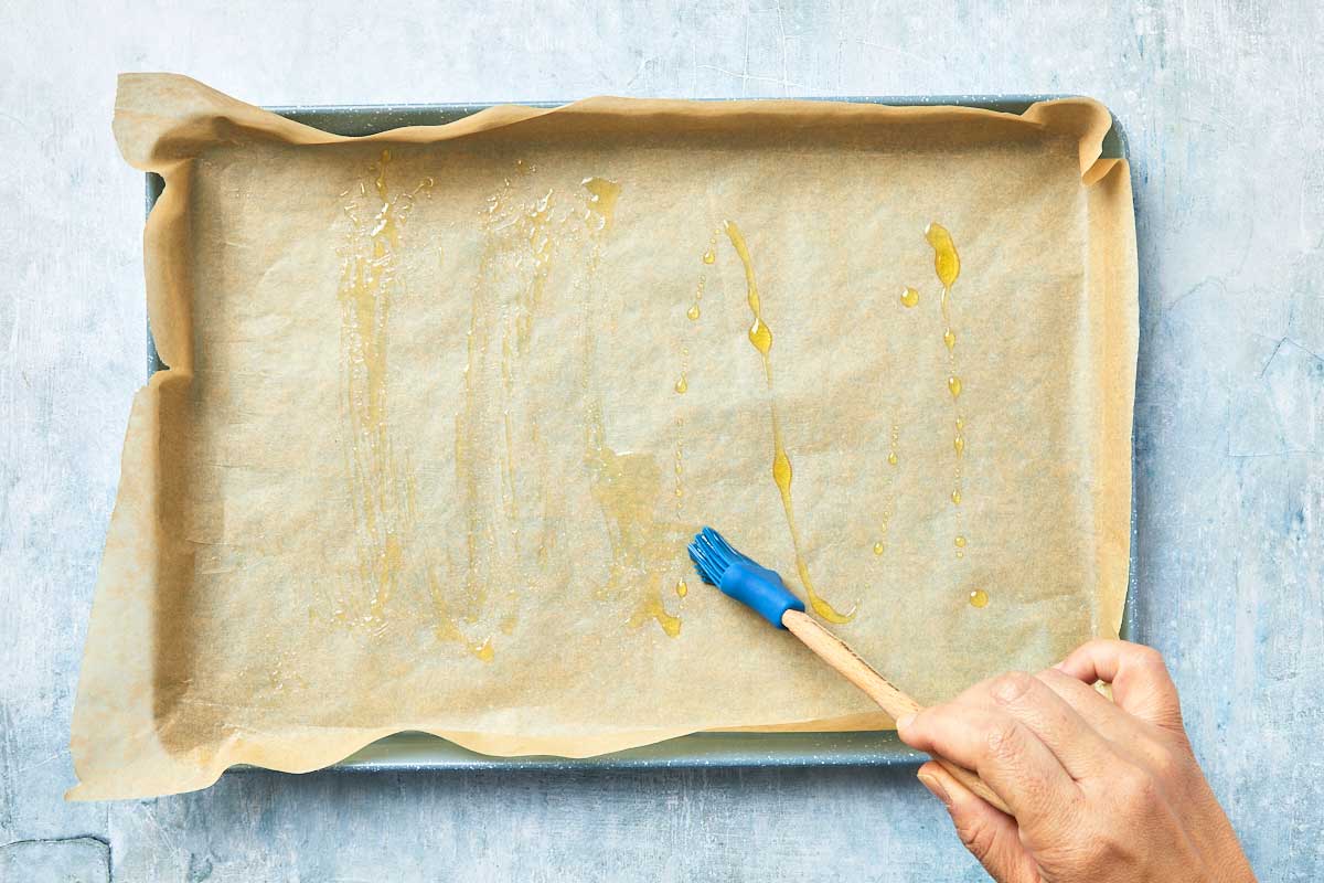 Rectangular baking pan lined with parchment and brushed with olive oil.