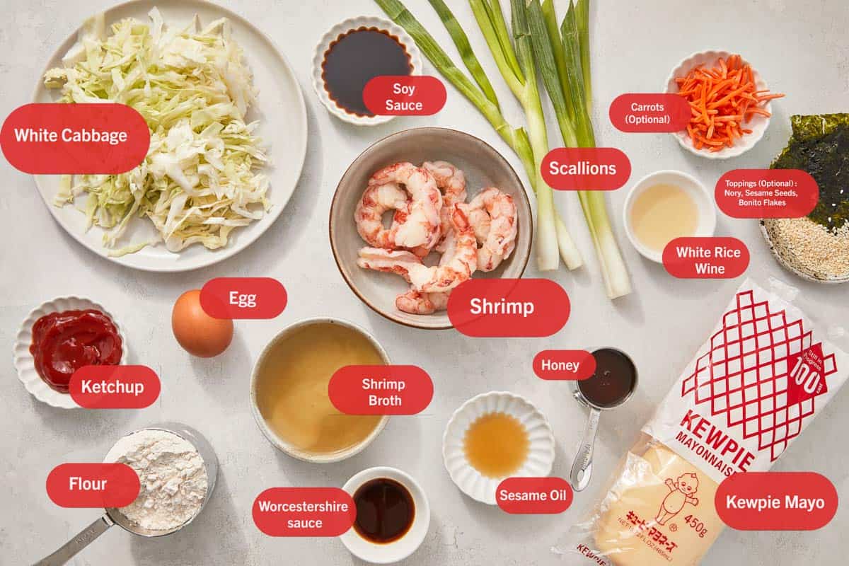 Flat lay of okonomiyaki ingredients, each labeled with red tags.
