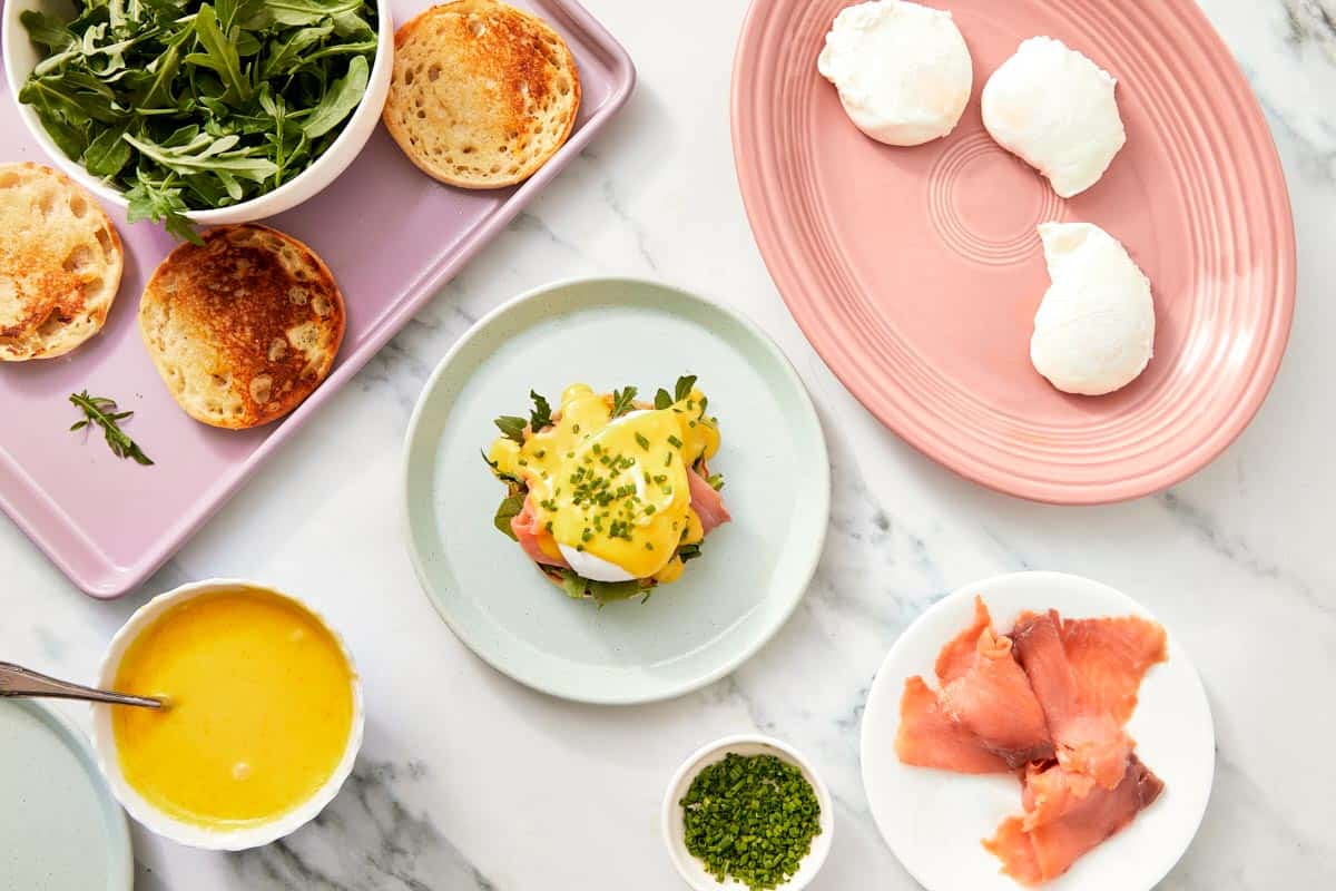 Fully assembled Eggs Benedict garnished with chopped chives and ready to serve.