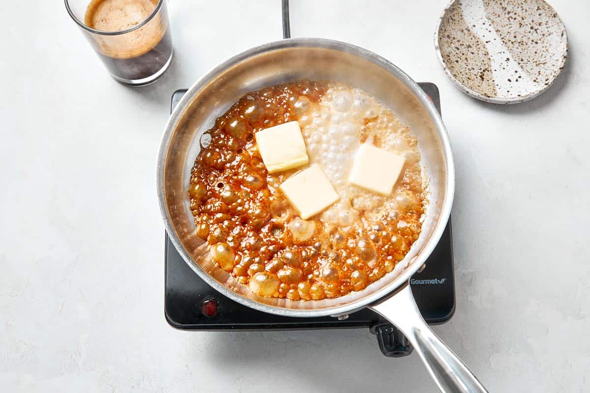 Warm cream, butter, and espresso into the caramelized sugar