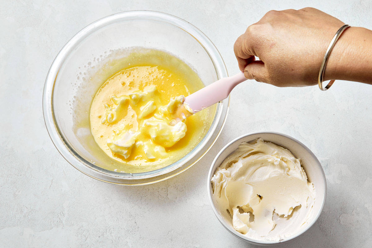 Chilling the mascarpone mixture over an ice bath until thick and creamy.