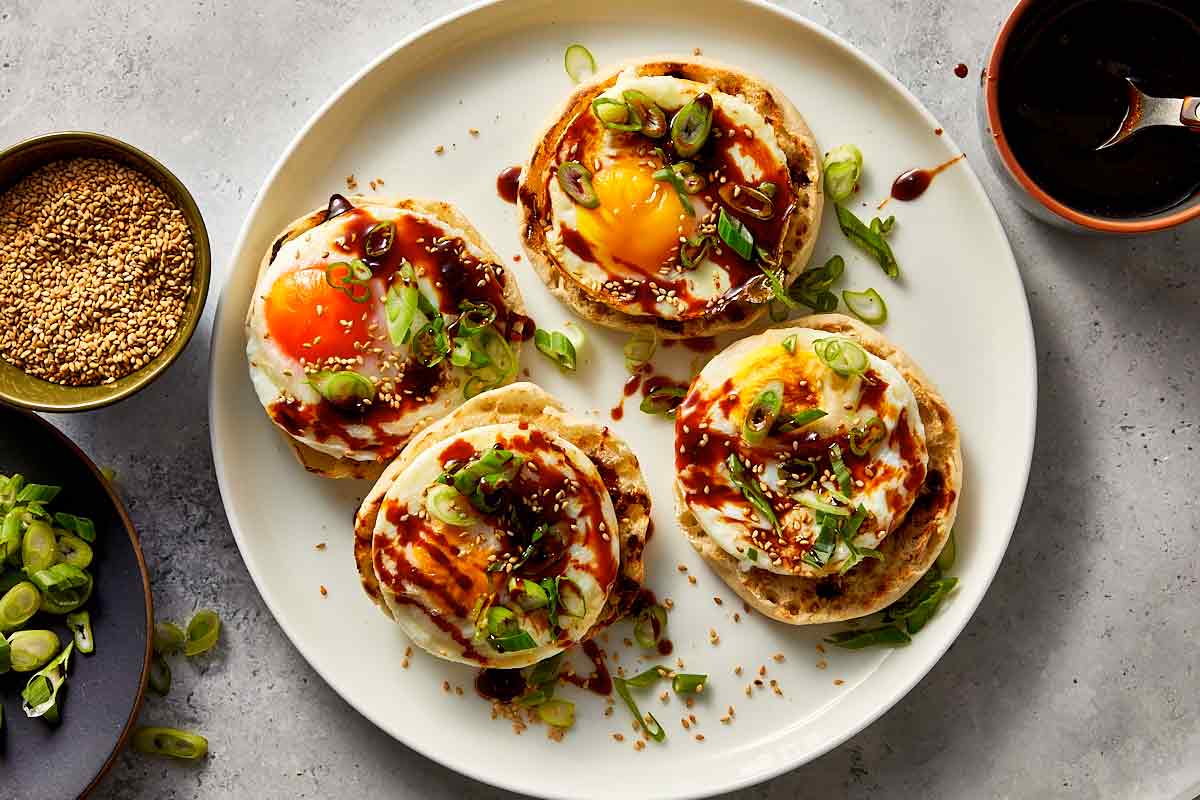 Top overview of teriyaki poached eggs garnish with green onion, teriyaki sauce and sesame oil