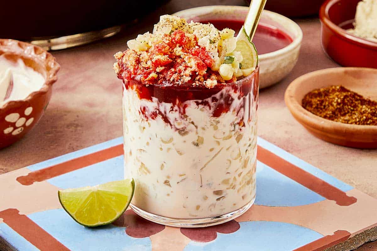 A spoon rests beside a warm dessert topped with a lime slice.