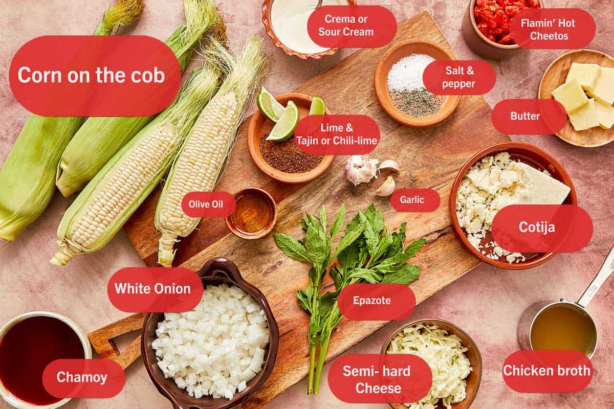 Ingredients for Esquites: fresh corn, butter, salt, and seasonings displayed on a rustic table.