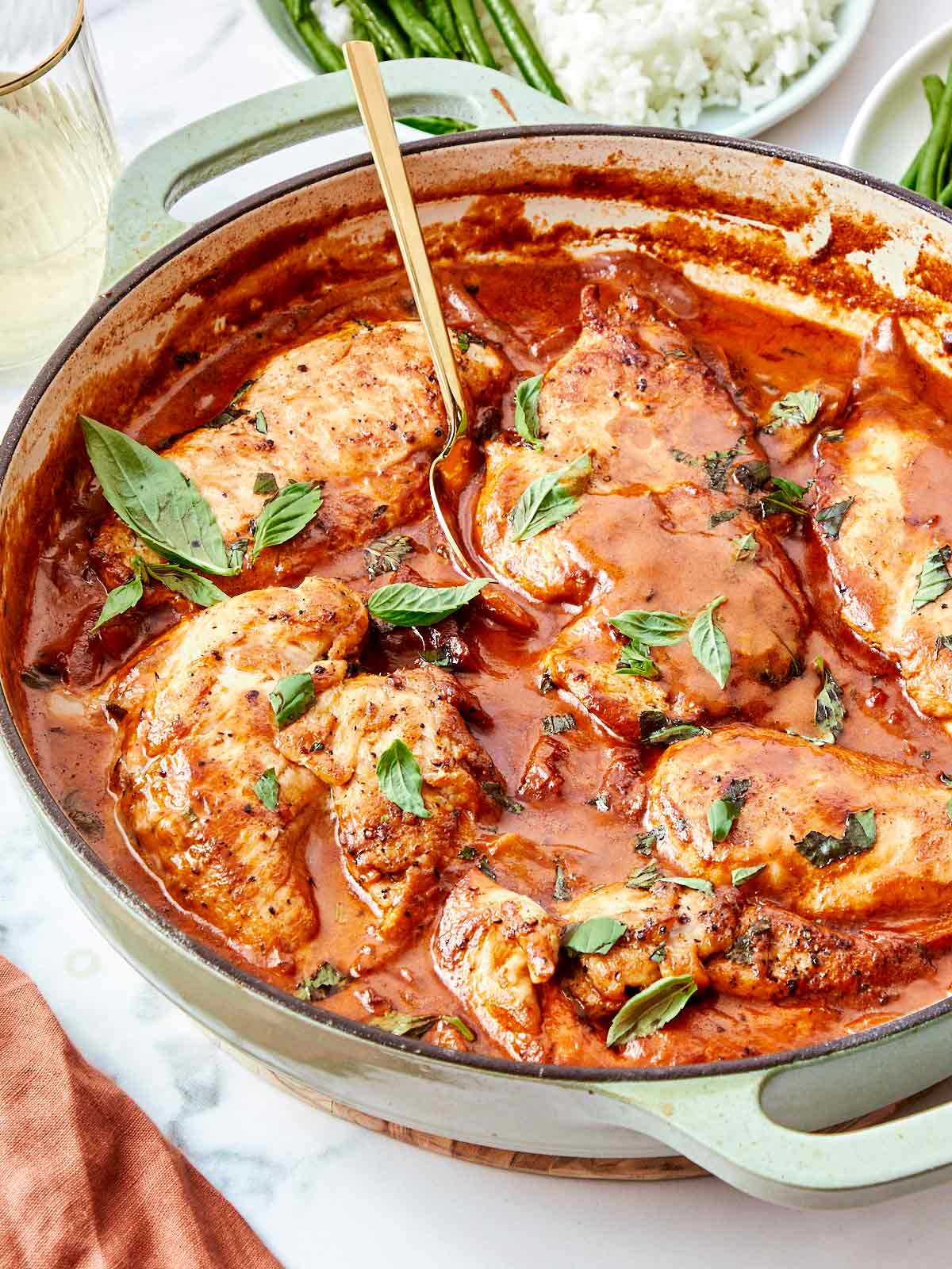 Creamy Marry Me Chicken simmering in a skillet, garnished with fresh basil and ready to serve.