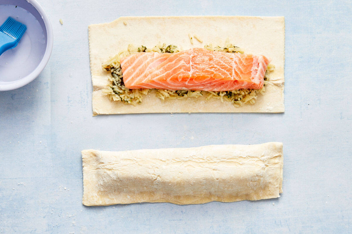 Salmon fillet placed over the spinach and rice mixture on pastry.