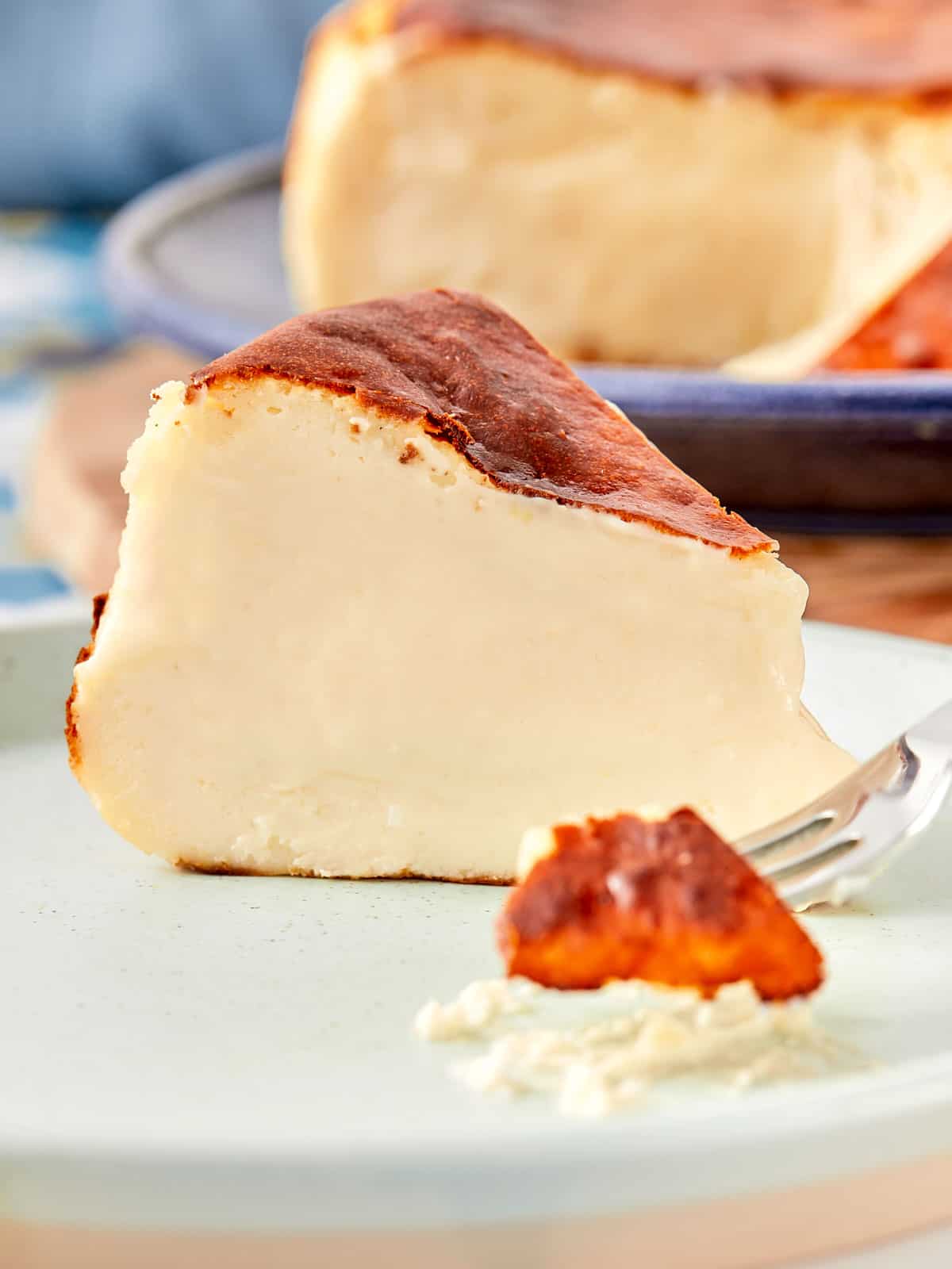 Close-up slice of Basque cheesecake with creamy center and caramelized