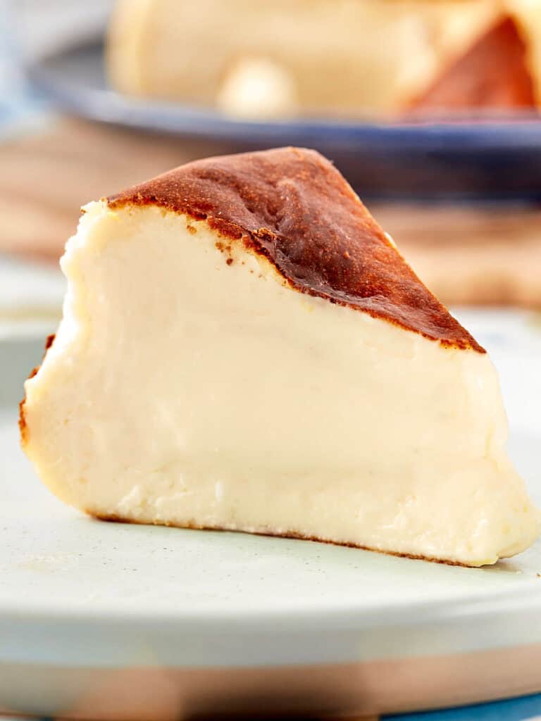 Close-up slice of Basque cheesecake with creamy center and caramelized