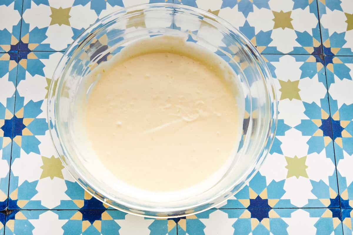 Cheesecake batter whisked smooth in a glass bowl