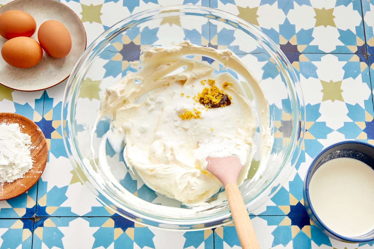 Sugar, vanilla, and lemon zest added to cream cheese mixture in a bowl