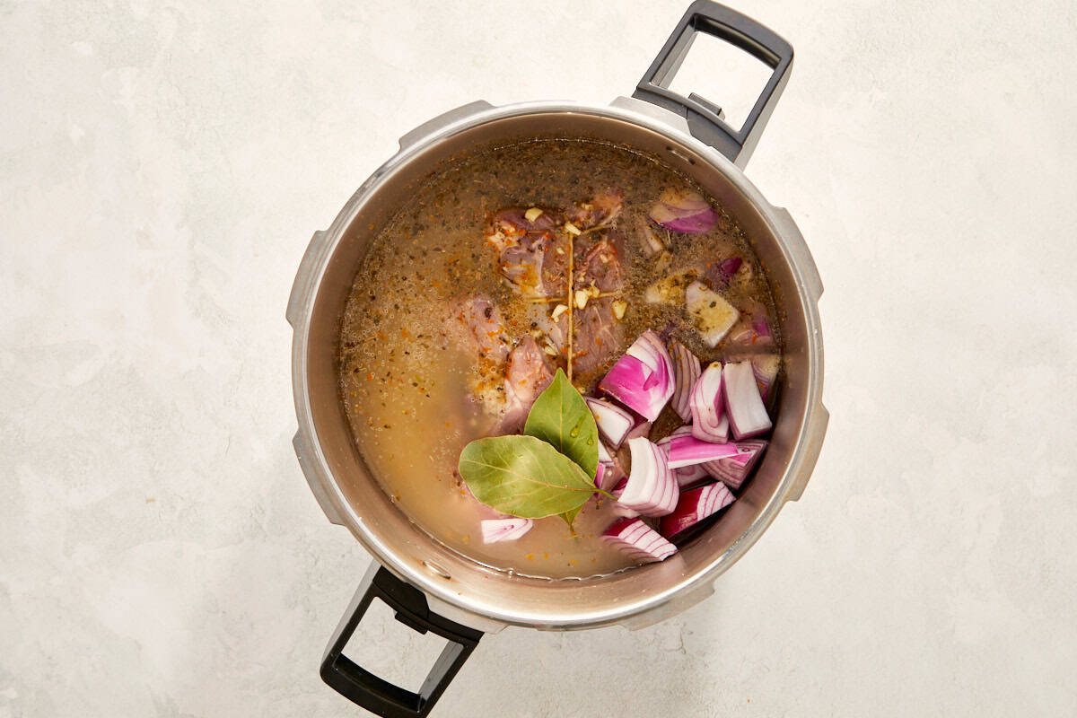Pork with onions and bay leaves in a pot