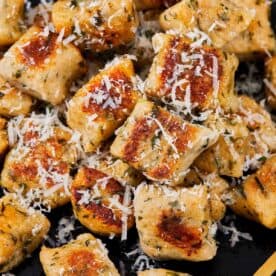Close-up of golden gnocchi pieces with parmesan shavings. - 11