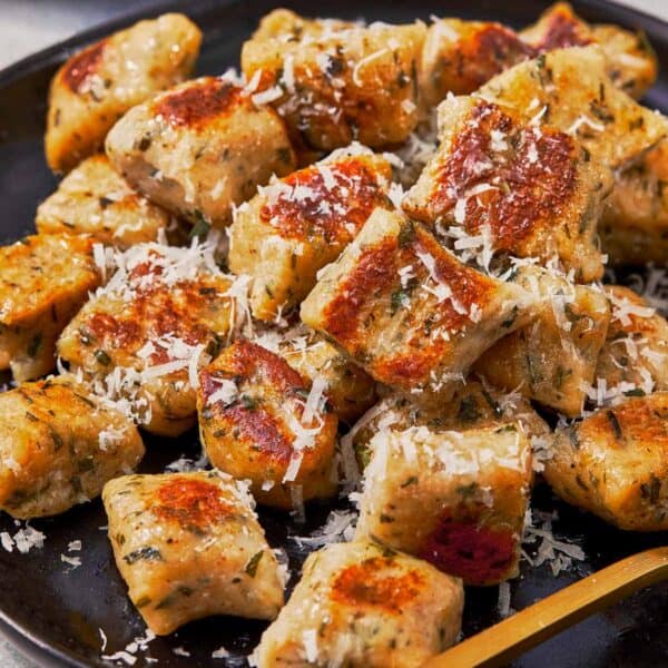 Crispy pan-fried gnocchi sprinkled with parmesan cheese.