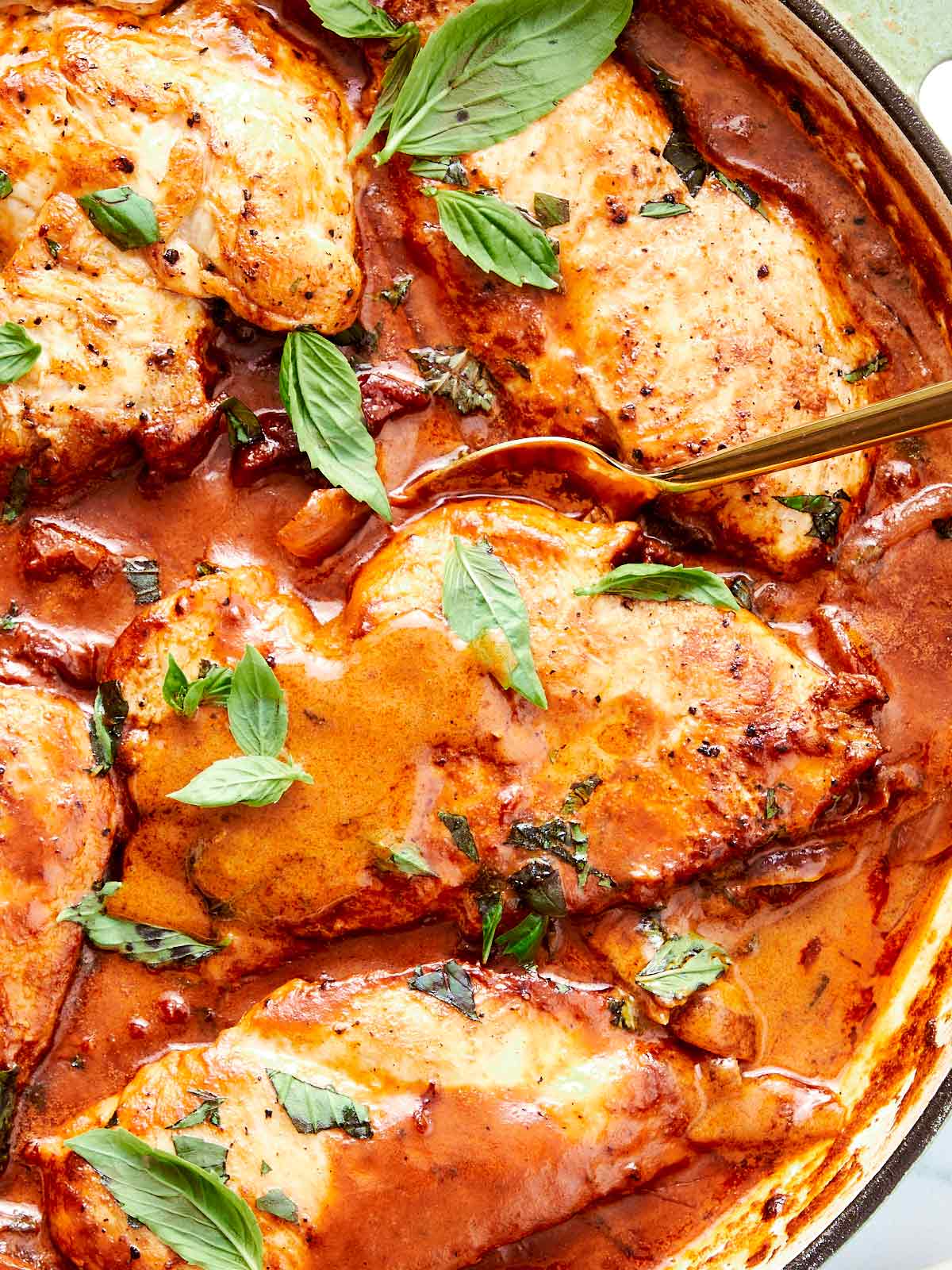Creamy Marry Me Chicken simmering in a skillet, garnished with fresh basil and ready to serve.
