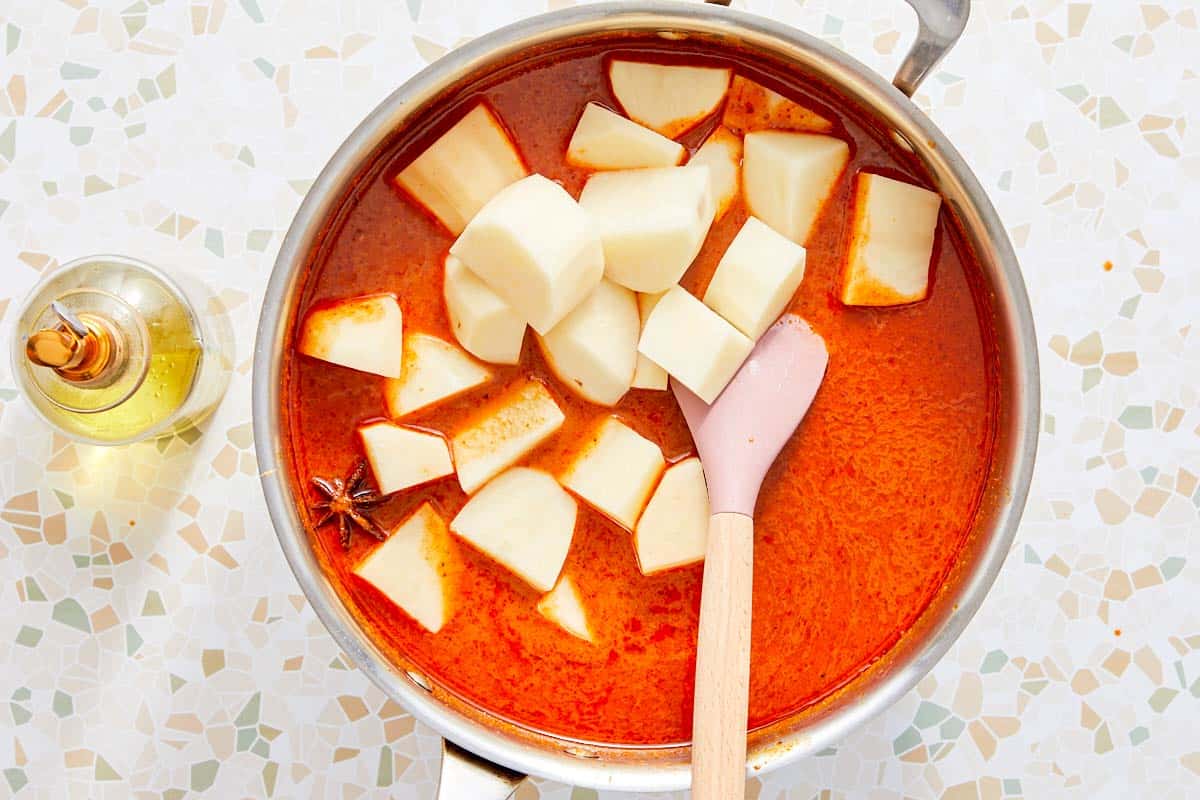 Potatoes added to simmering Massaman curry.