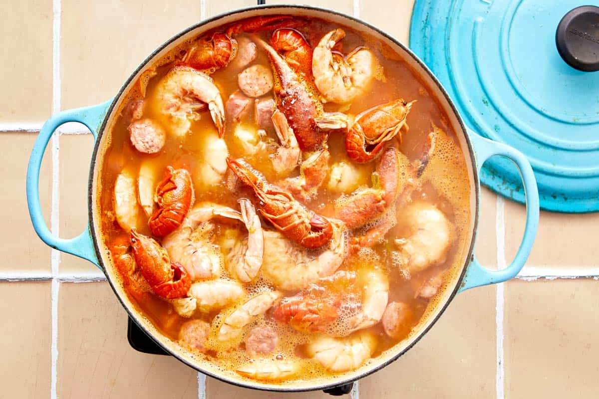 Shrimp, crab, and crawfish bubbling in the pot as the final layer of the boil cooks.

