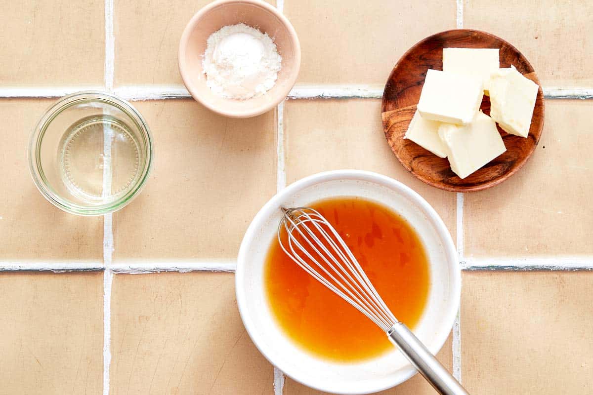 Butter, cornstarch, and broth being whisked together in a bowl for the dipping sauce.

