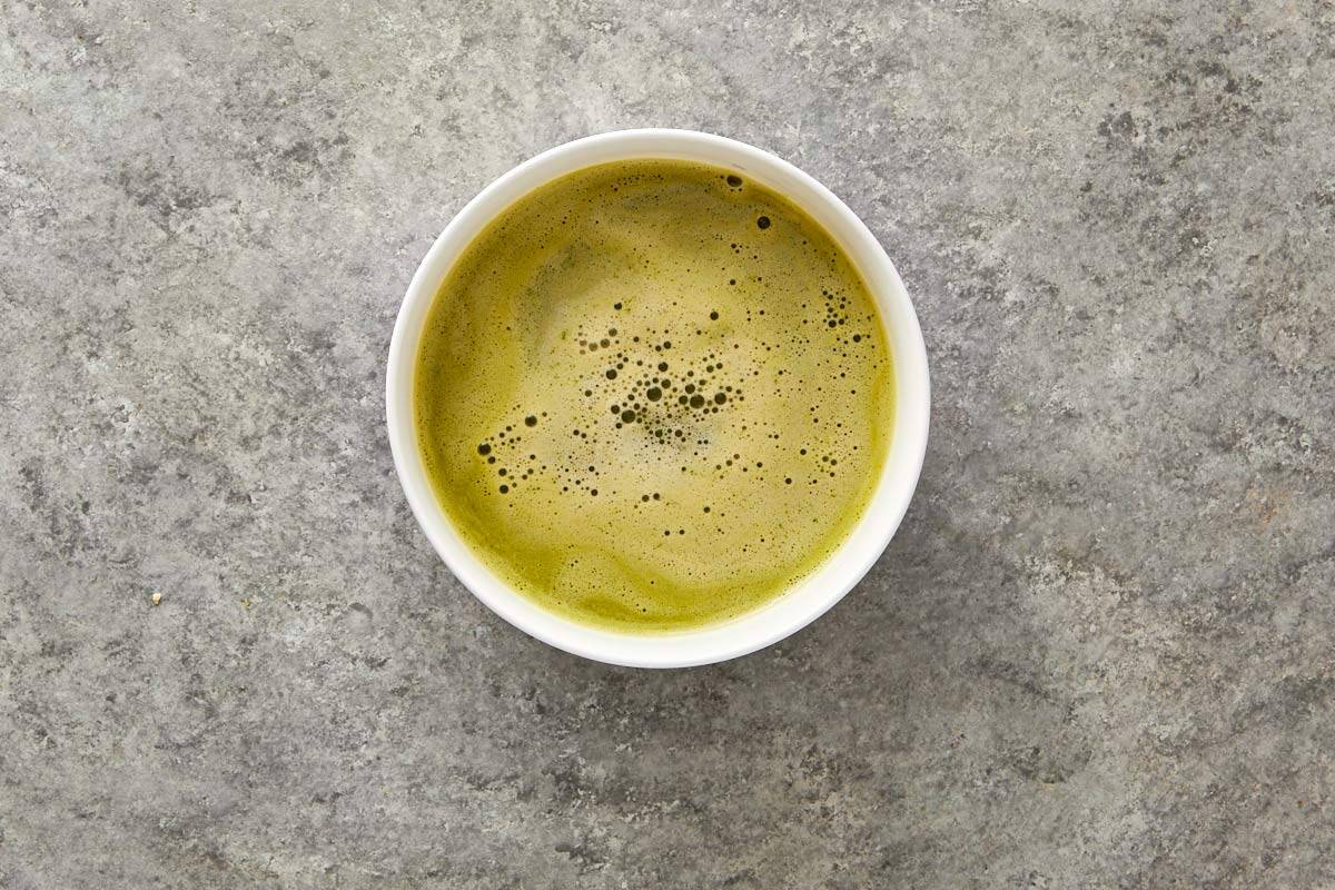 Chilled marinade in a white bowl after straining.