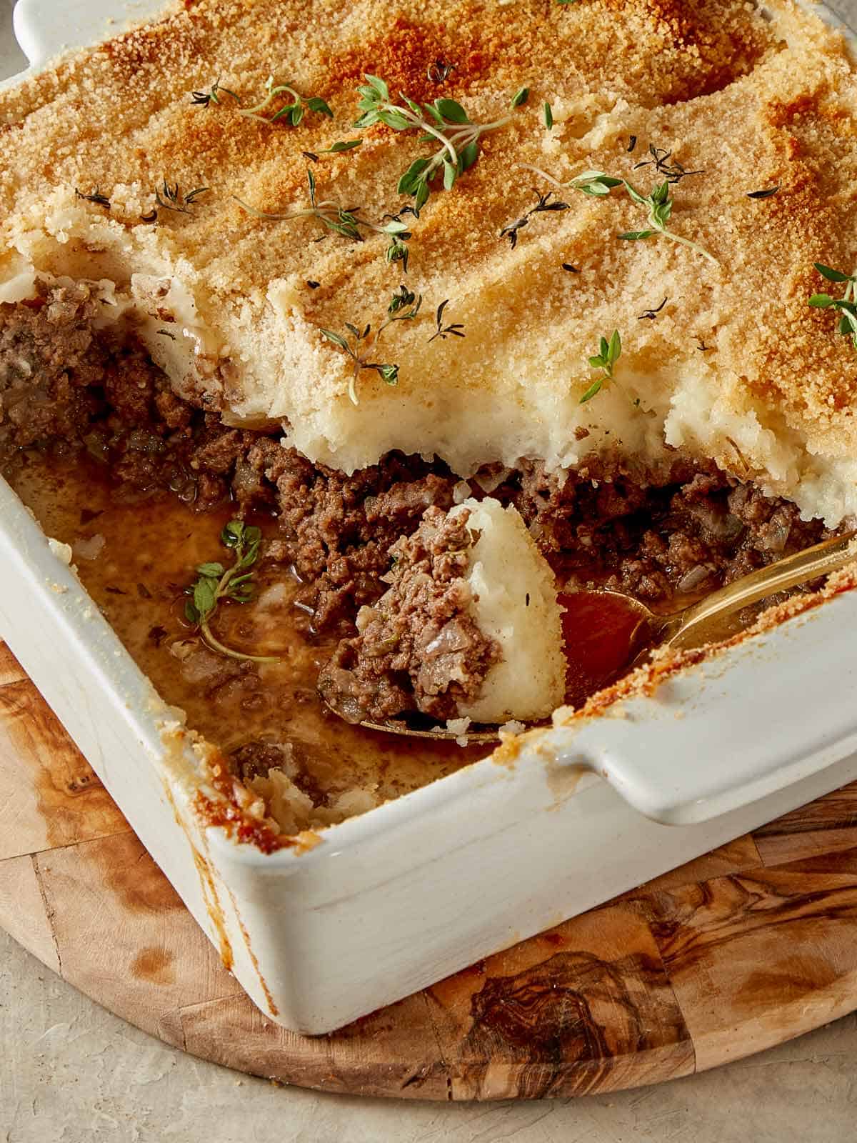 Slice of Shepherd’s Pie with golden mashed potato topping on a plate.