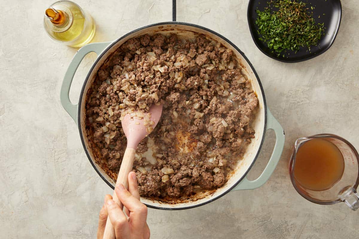 Ground meat browning in a skillet for the filling.