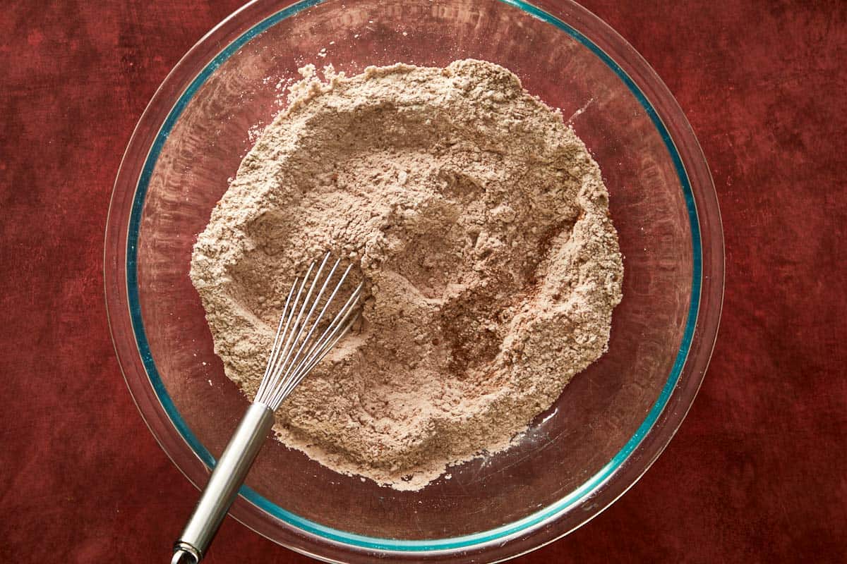 Mixing dry ingredients for cocoa chiffon cake — flour, cocoa, and sugar.