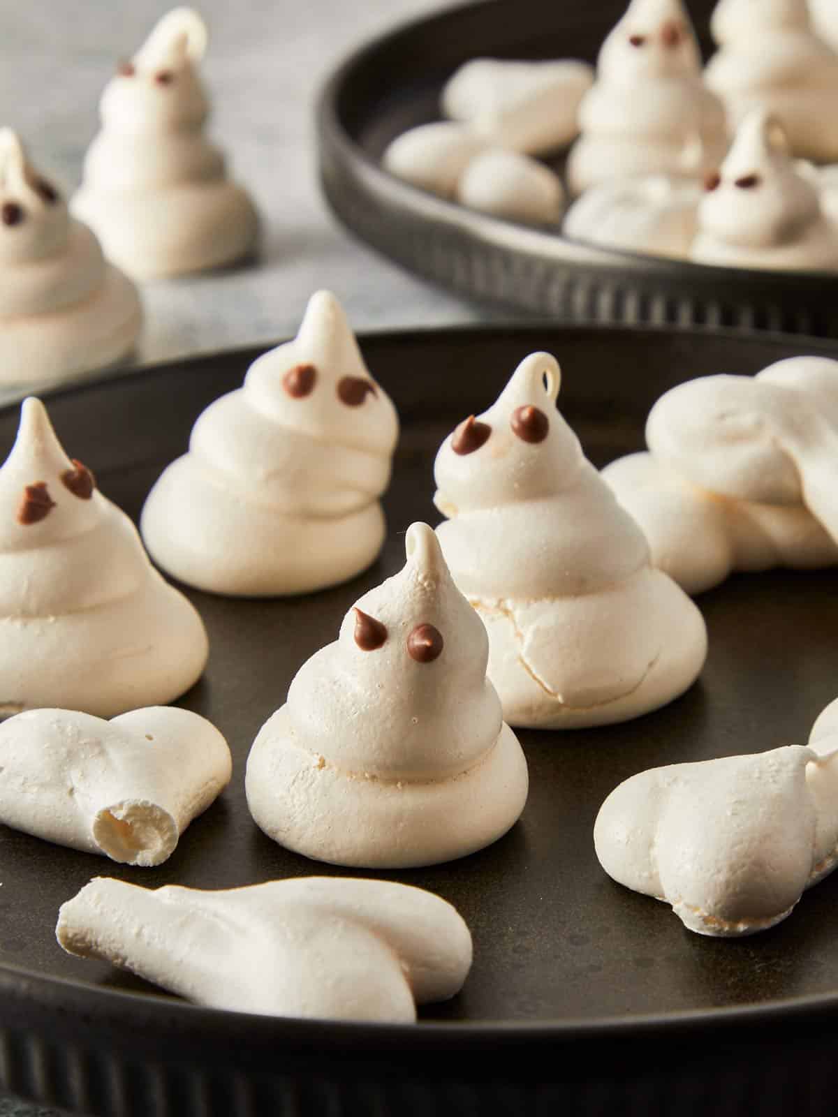 Plated Swiss meringue ghosts and bones ready to serve for Halloween.