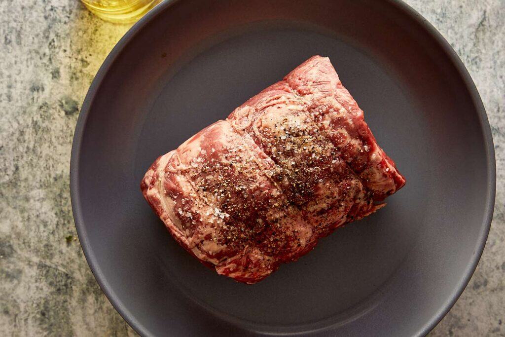 a raw beef log on a plate