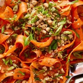 carrot salad with peanuts on top and a spoon on the side - 11